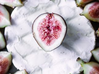 A close up shot of figs on top of brie.