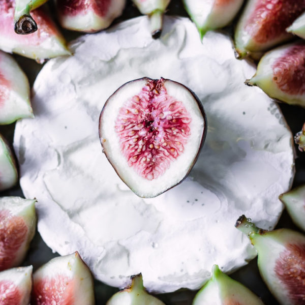 A close up shot of figs on top of brie.