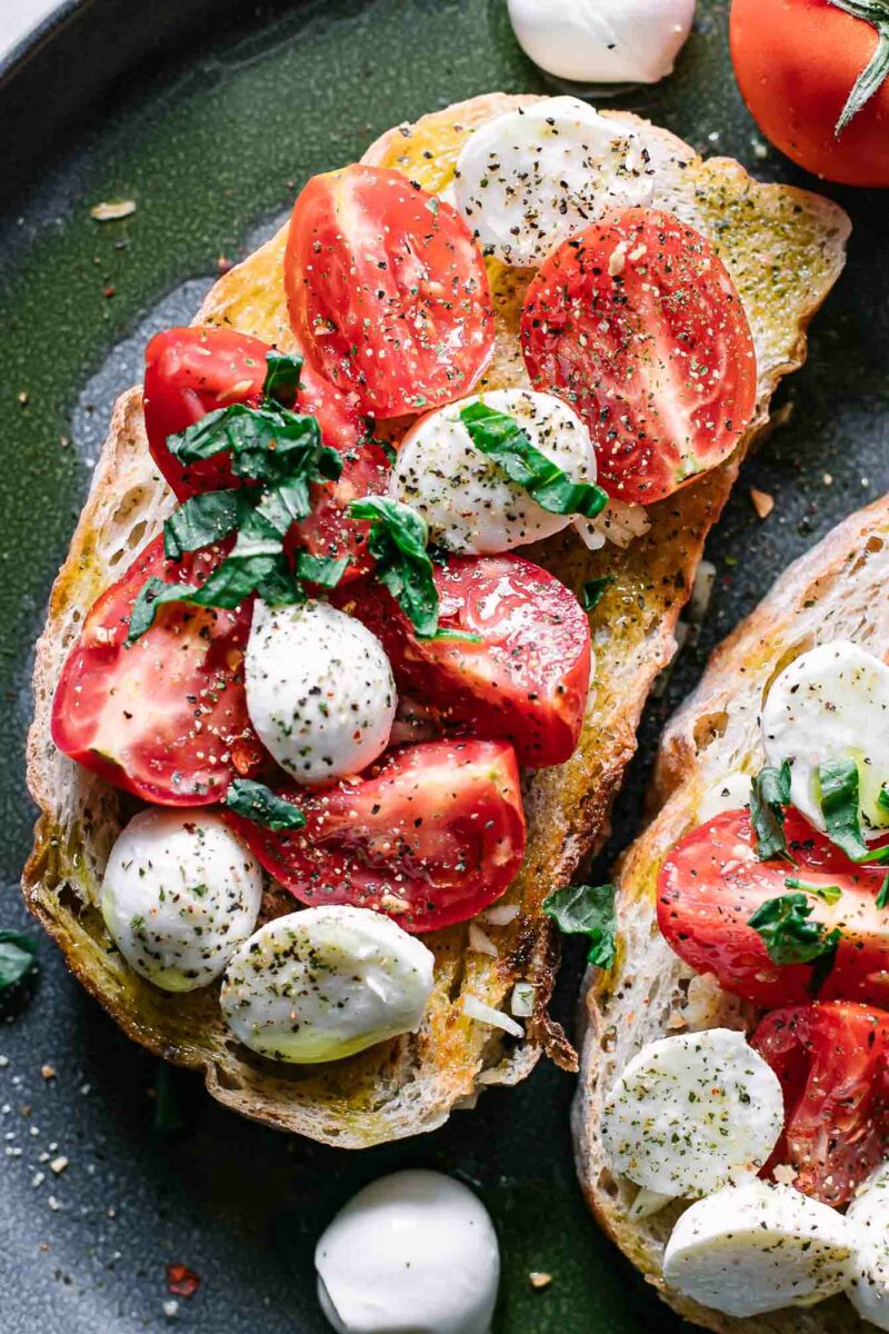 caprese salad on ciabatta toast on a blue plate