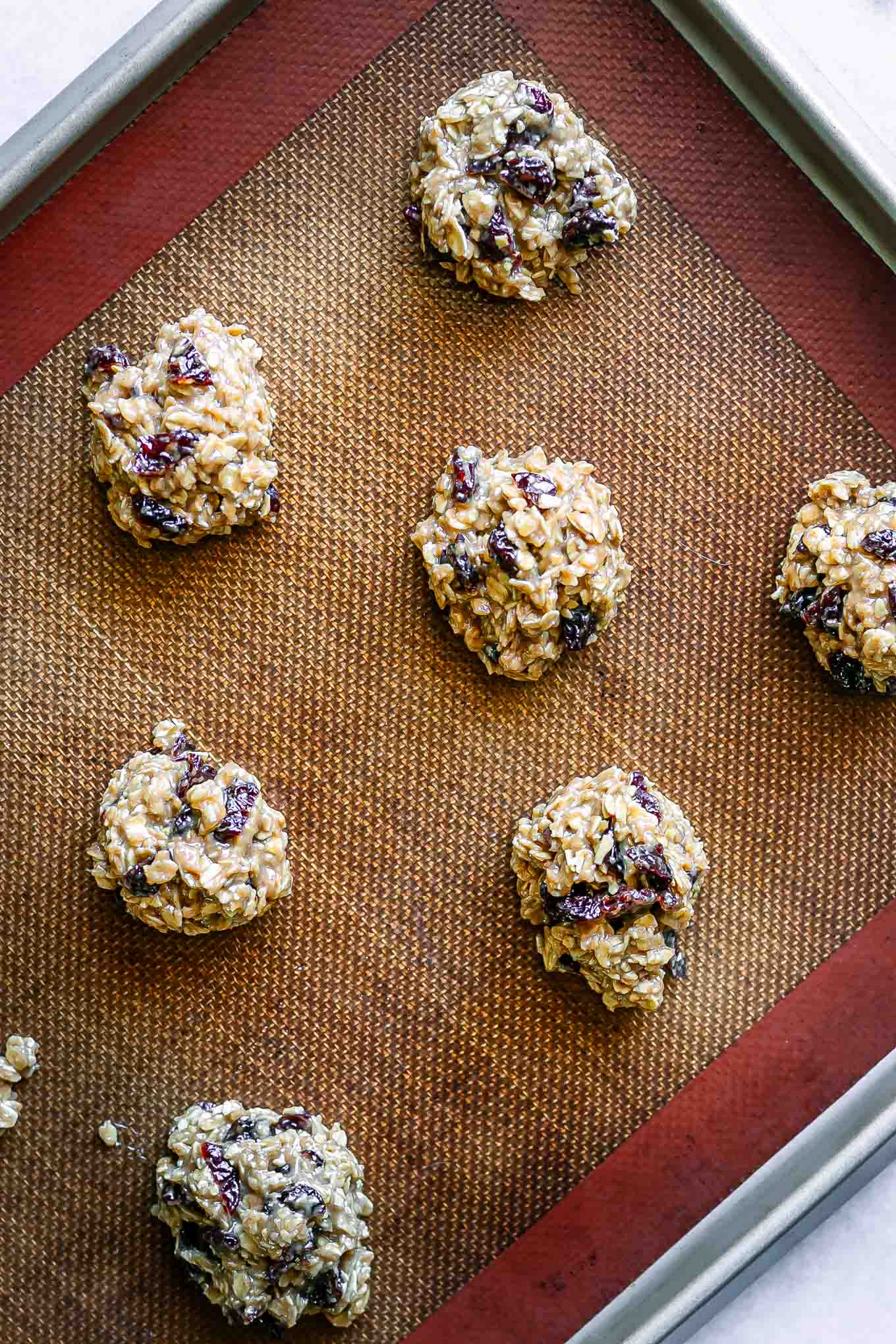 cherry oatmeal cookie dough on a baking sheet before baking