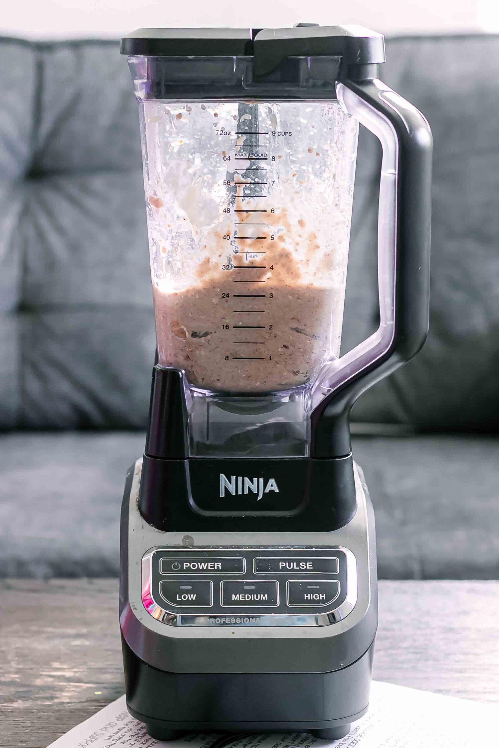 muffin batter in a blender on a wood table