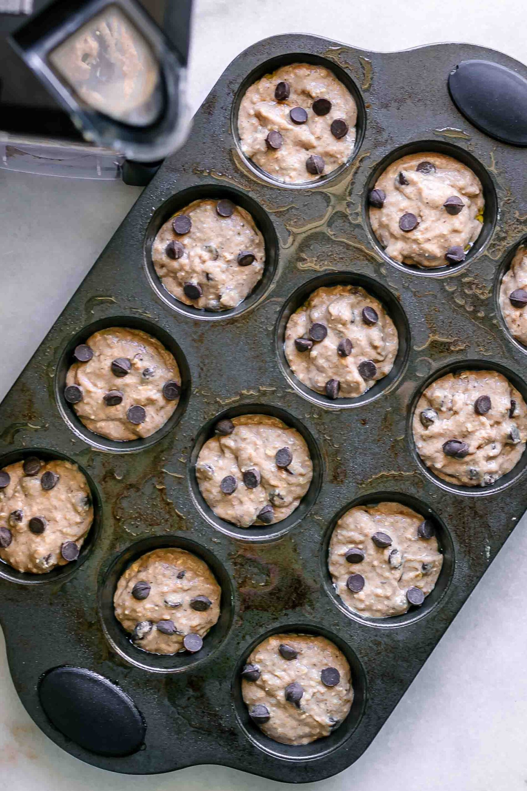 banana bread muffin batter in a muffin tin before baking