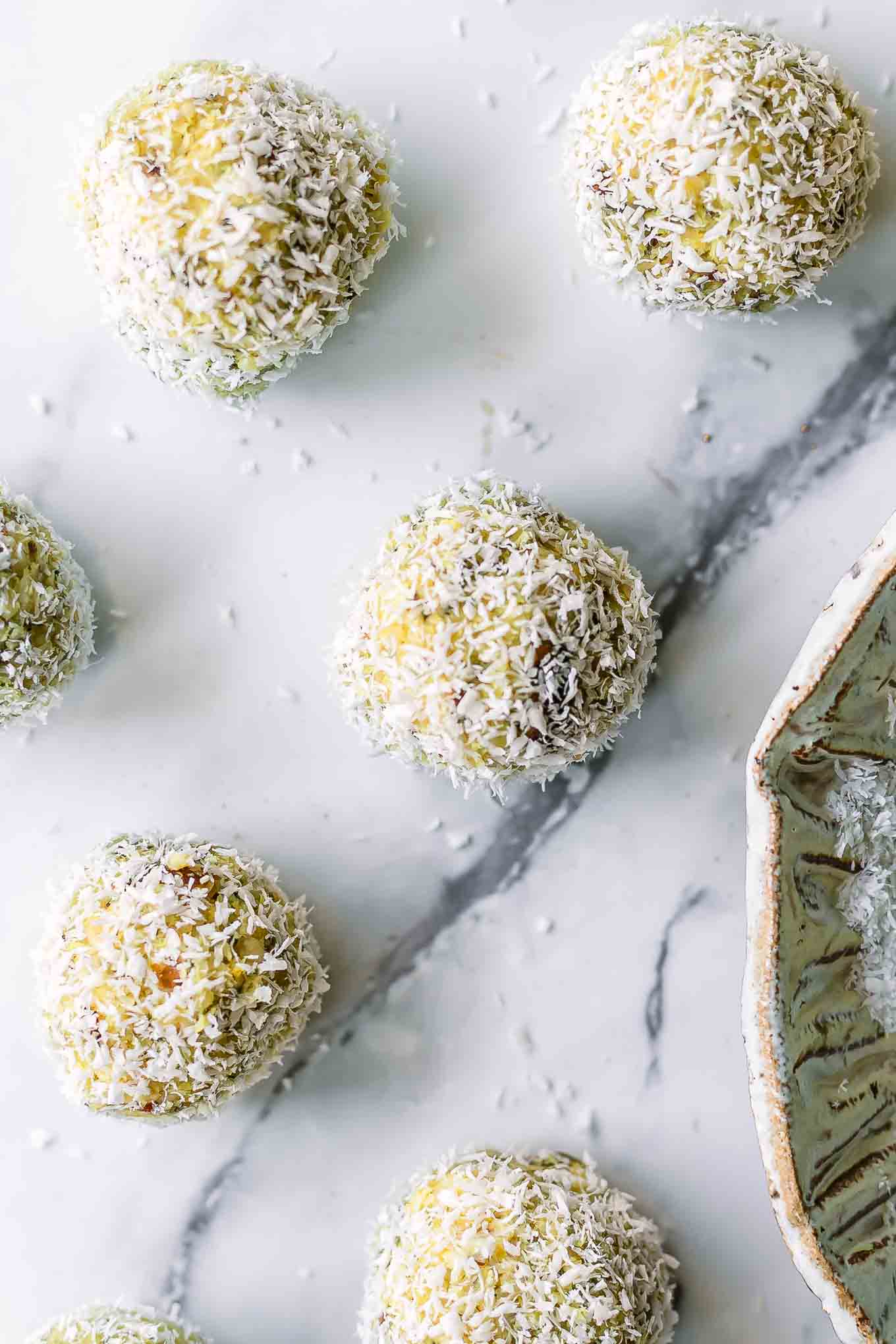 small coconut lemon energy balls on a white table