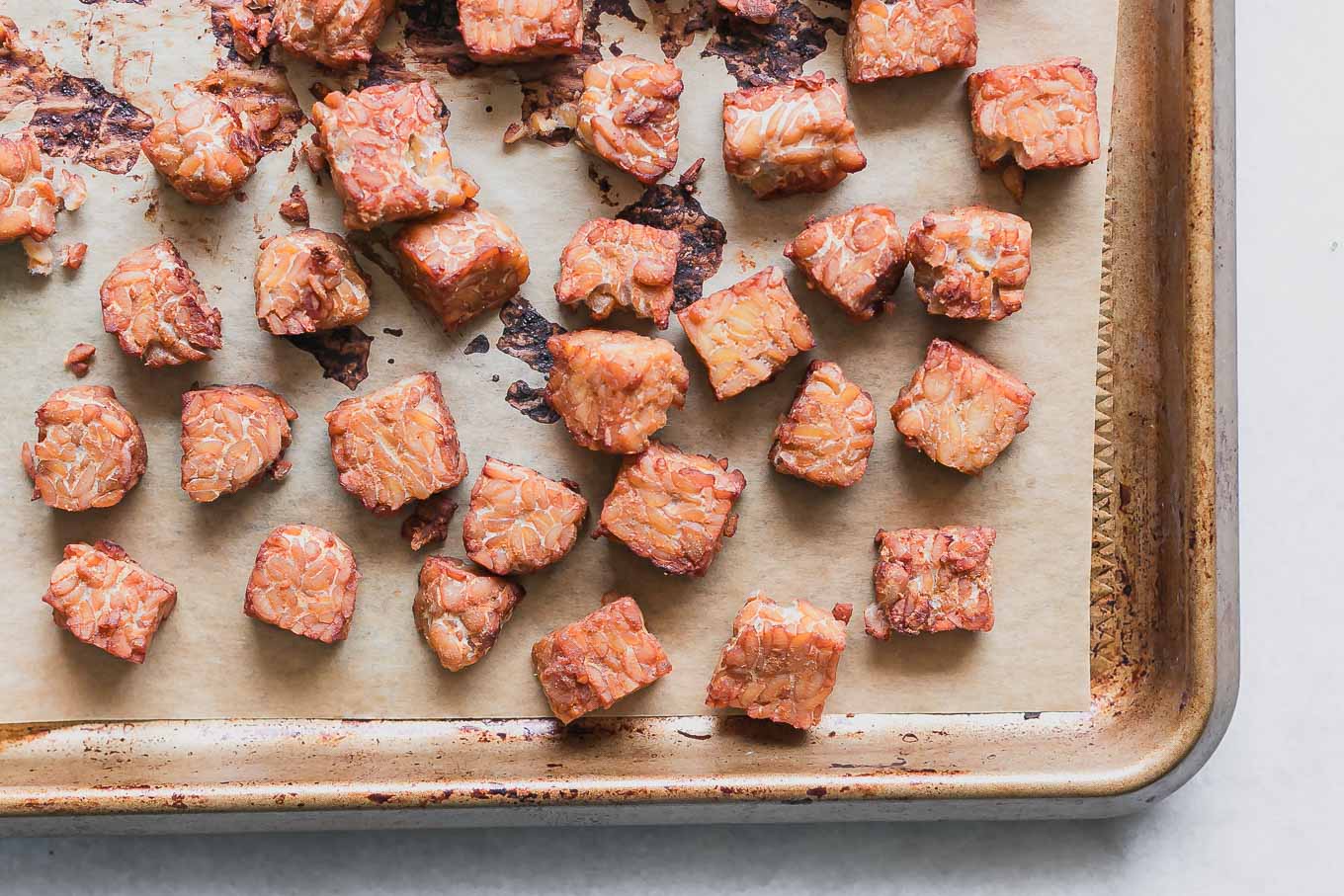 crispy tempeh on a sheet pan after baking