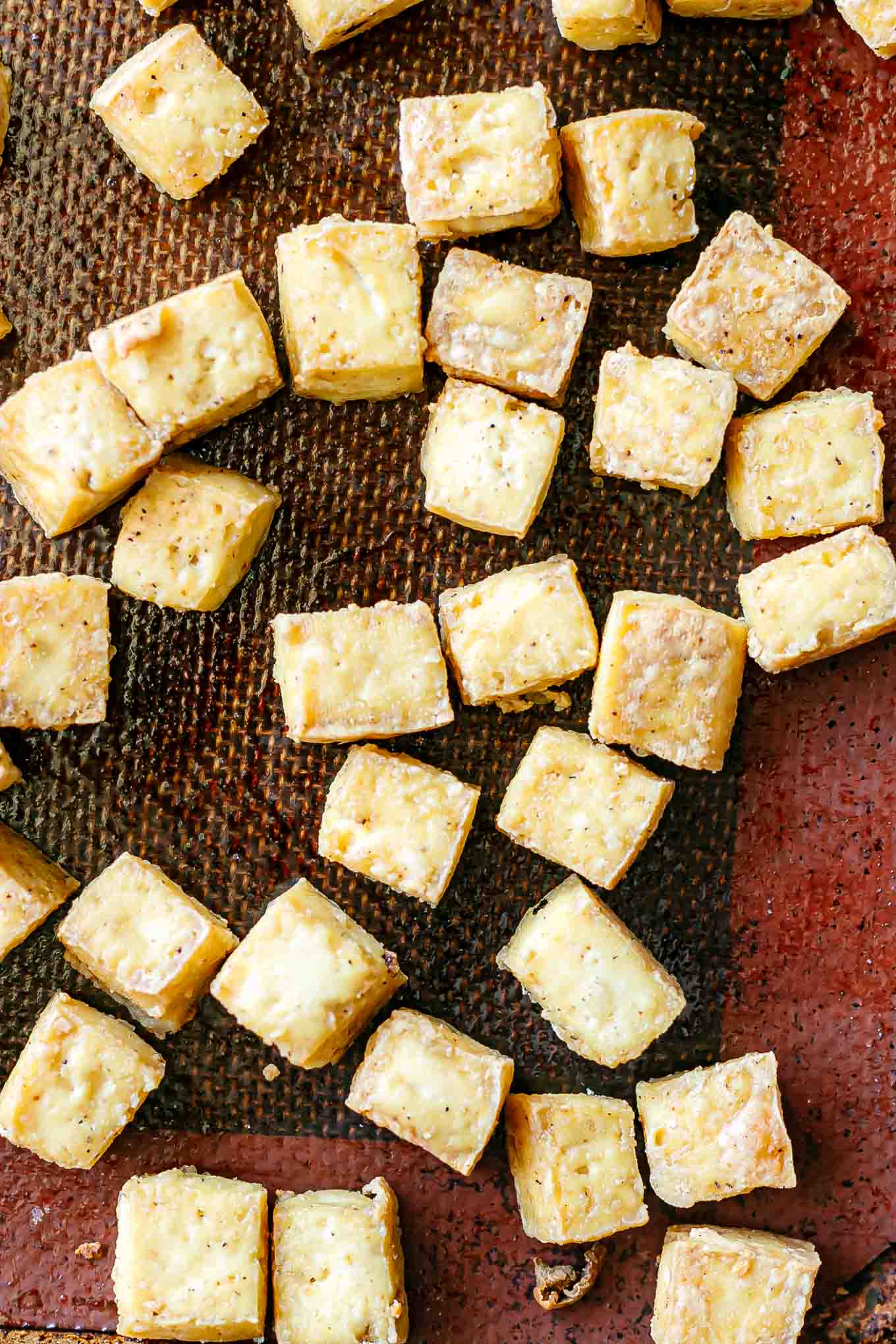 crispy tofu on a sheet pan after baking