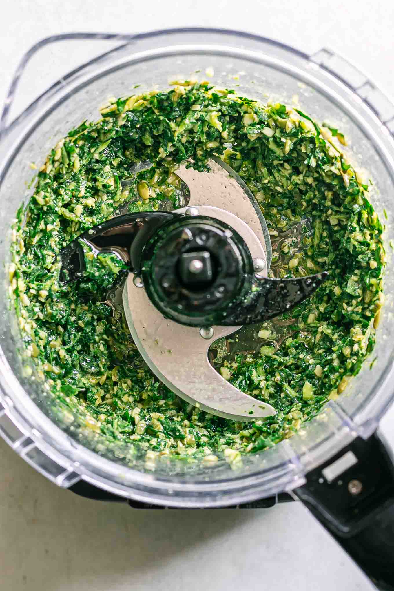 blended dandelion pesto sauce inside a food processor