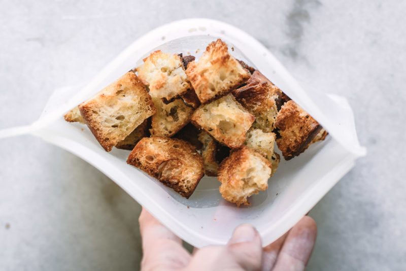 croutons in a silicon freezer bag on a white countertop