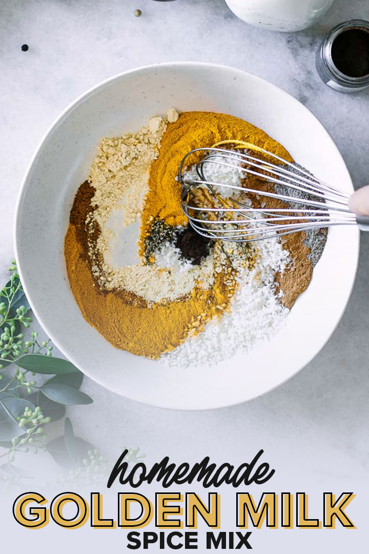a white bowl with spices being mixed by a hand with a whisk and the words "homemade golden milk spice mix" in black and orange letters