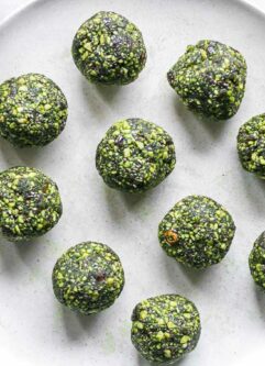 green energy balls with green tea matcha powder on a white plate