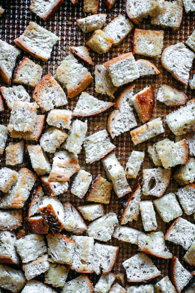cooked rye croutons on a baking sheet