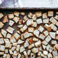 rye bread croutons on a baking sheet