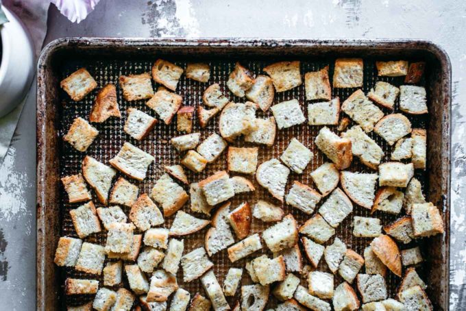 baked rye croutons on a baking sheet