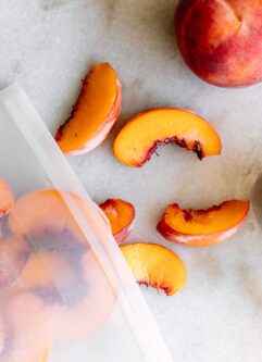 a bag of frozen peach slices on a white table
