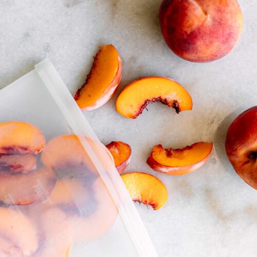 a bag of frozen peach slices on a white table