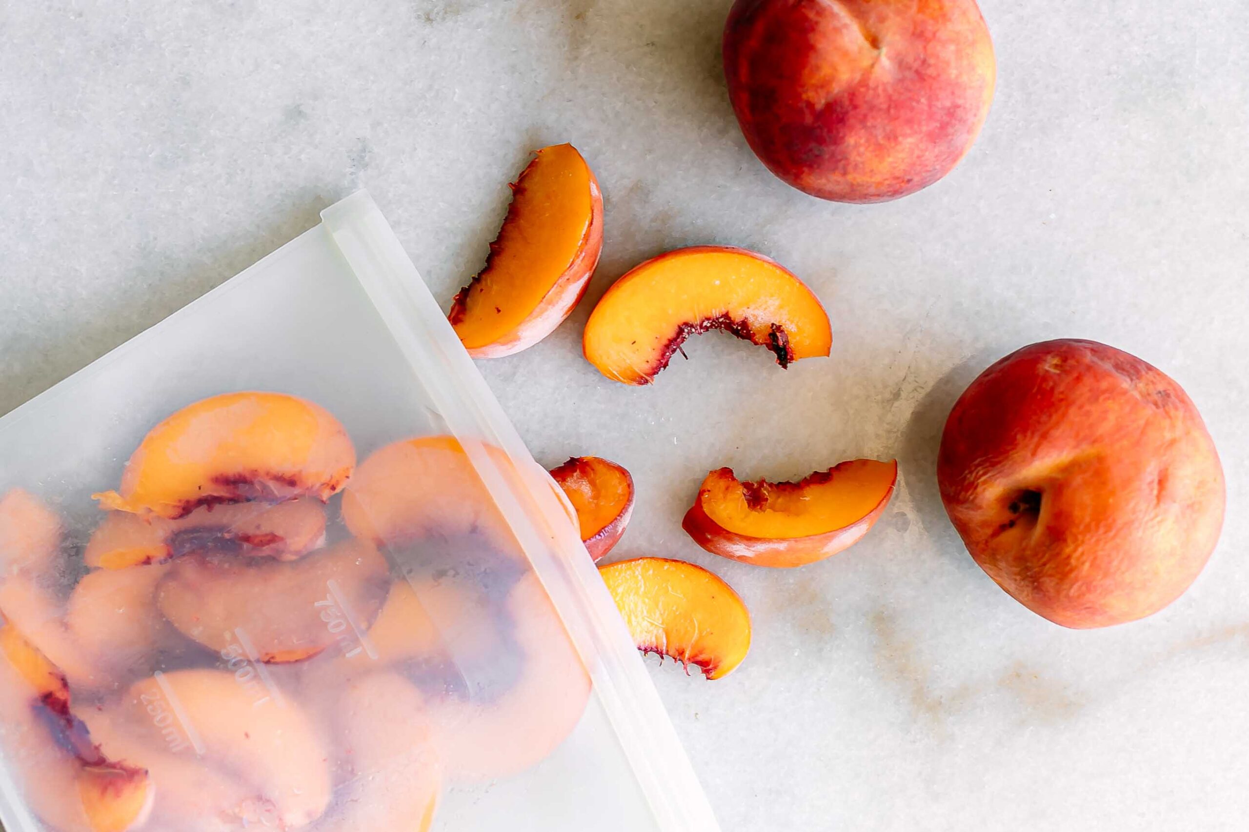 a bag of frozen peach slices on a white table