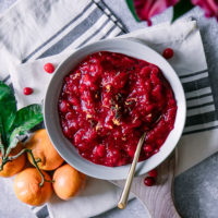 A bowl of cranberry sauce with orange zest and thyme