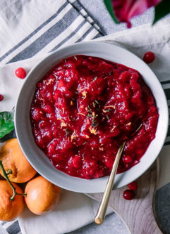 A bowl of cranberry sauce with orange zest and thyme