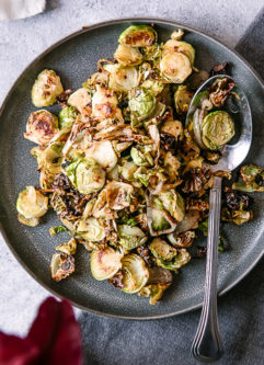 A simple brussels sprouts side dish on a white table for Thanksgiving