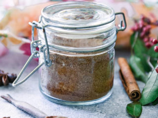 a small jar of masala chai spice blend with a small wooden spoon and the worlds "homemade masala chai spice blend" in black writing