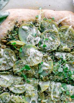 a pizza topped with micro greens and lemon zest