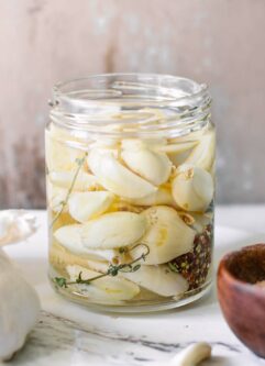 a jar of pickled vegetables on on a white table