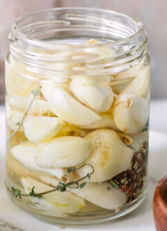 pickled garlic in a jar on a white table
