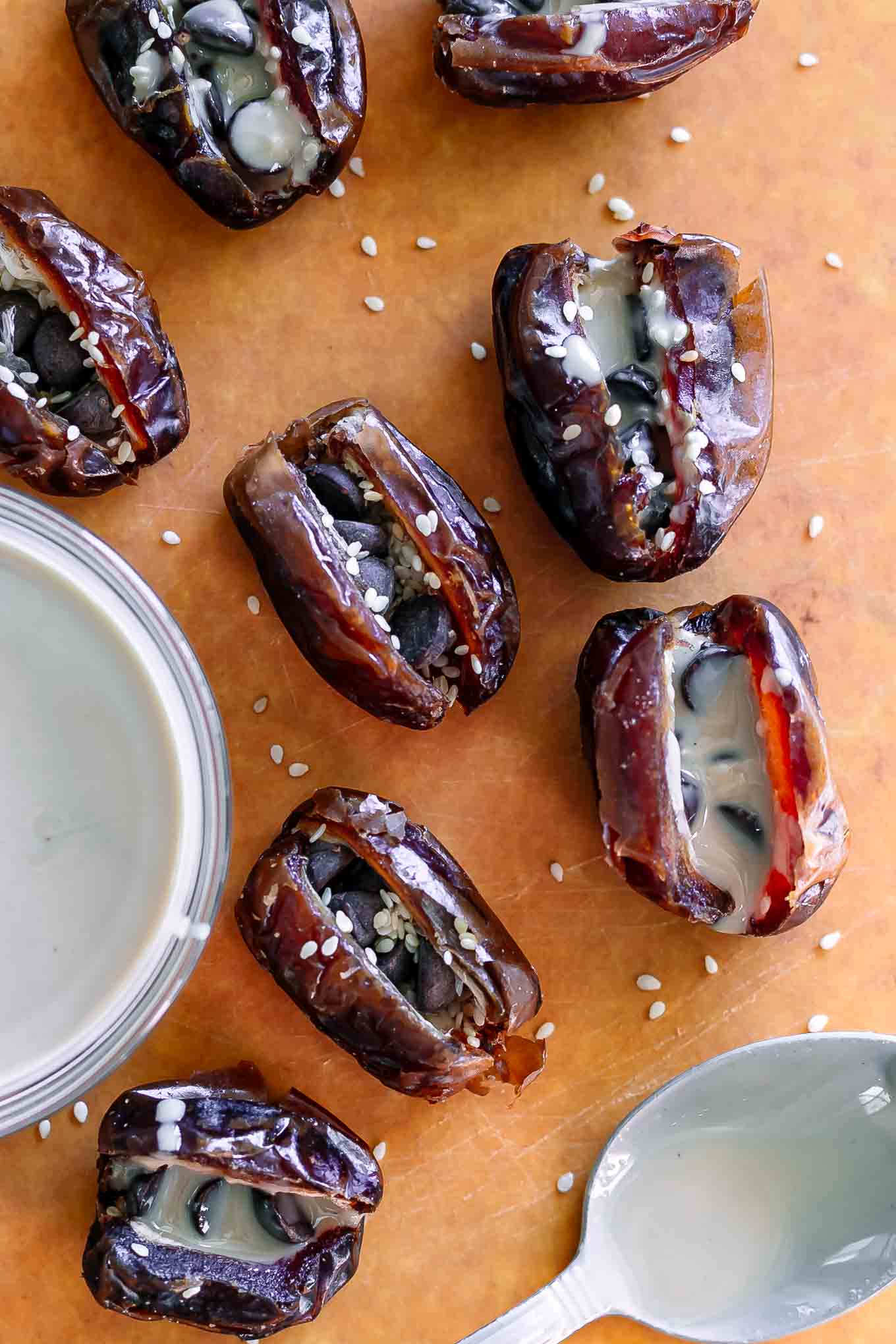 dates stuffed with tahini on a wood cutting board