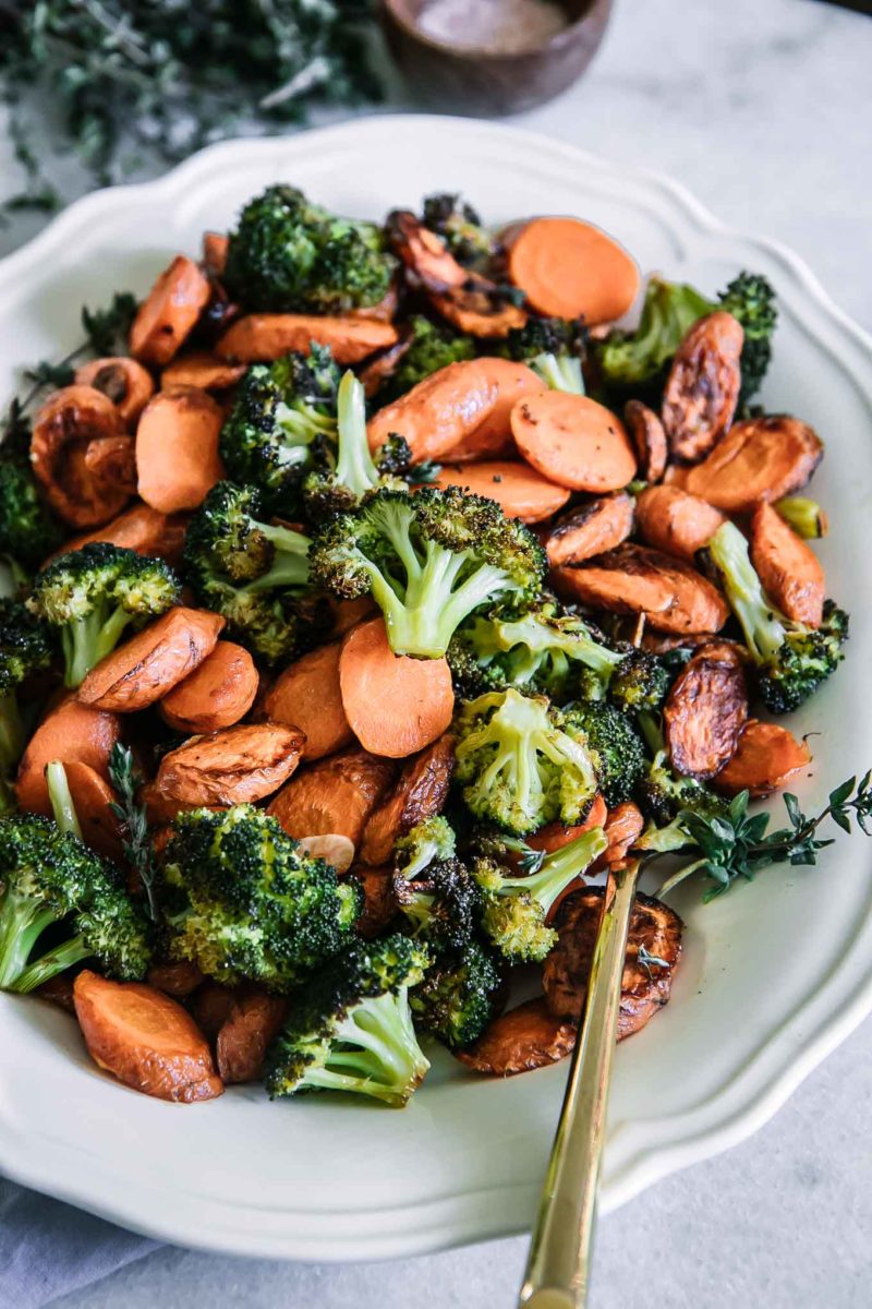 oven roasted carrots and broccoli on a white plate with a gold fork