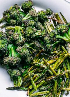 roasted broccoli and asparagus on a white side dish plate
