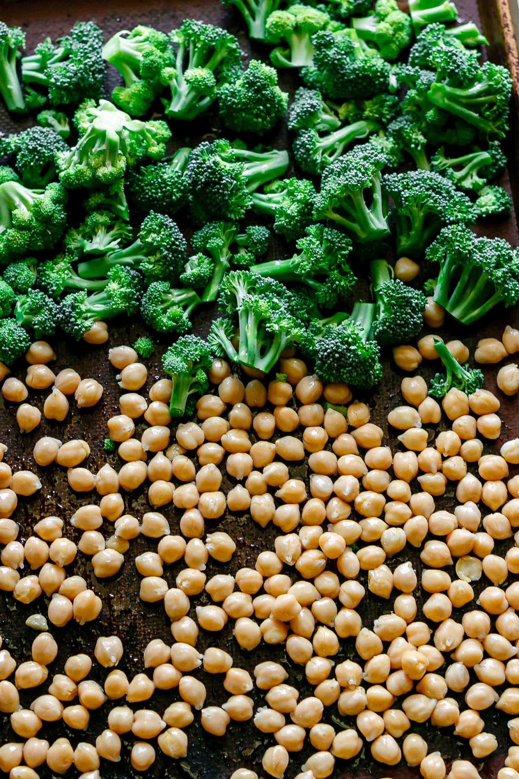 broccoli and chickpeas on a baking sheet before roasting