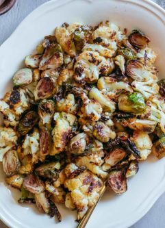 roasted brussels sprouts and cauliflower in a serving dish