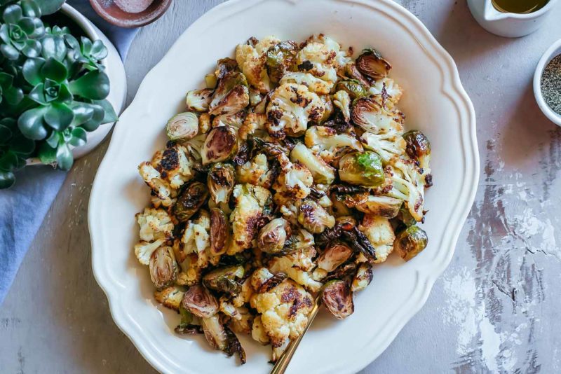 roasted brussels sprouts and cauliflower in a serving dish