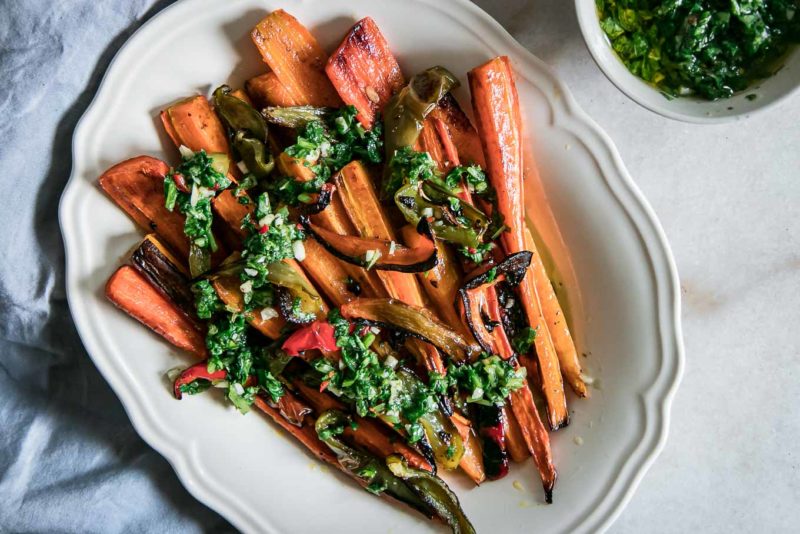 long roasted carrots and sliced bell peppers on a white plate