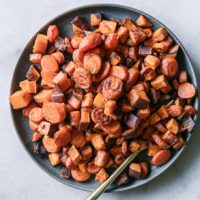 baked sweet potatoes and carrots on a blue plate