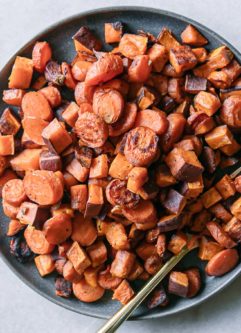 baked sweet potatoes and carrots on a blue plate