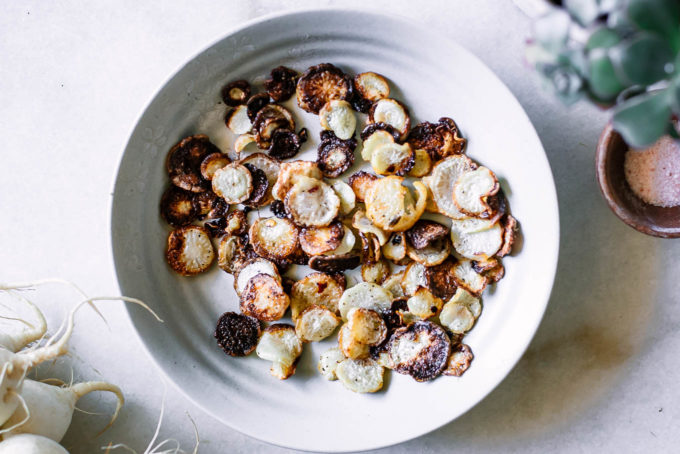 roasted turnip chips in a white bowl