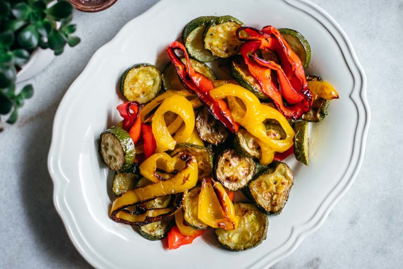 roasted zucchini and bell peppers on a white plate