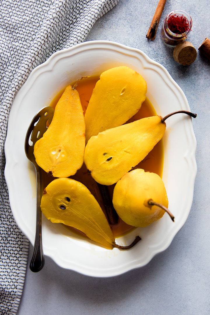 Saffron Poached Pears, a simple and seasonal fall and winter baked fruit dessert with saffron, apple cider vinegar, cinnamon, and brown sugar.