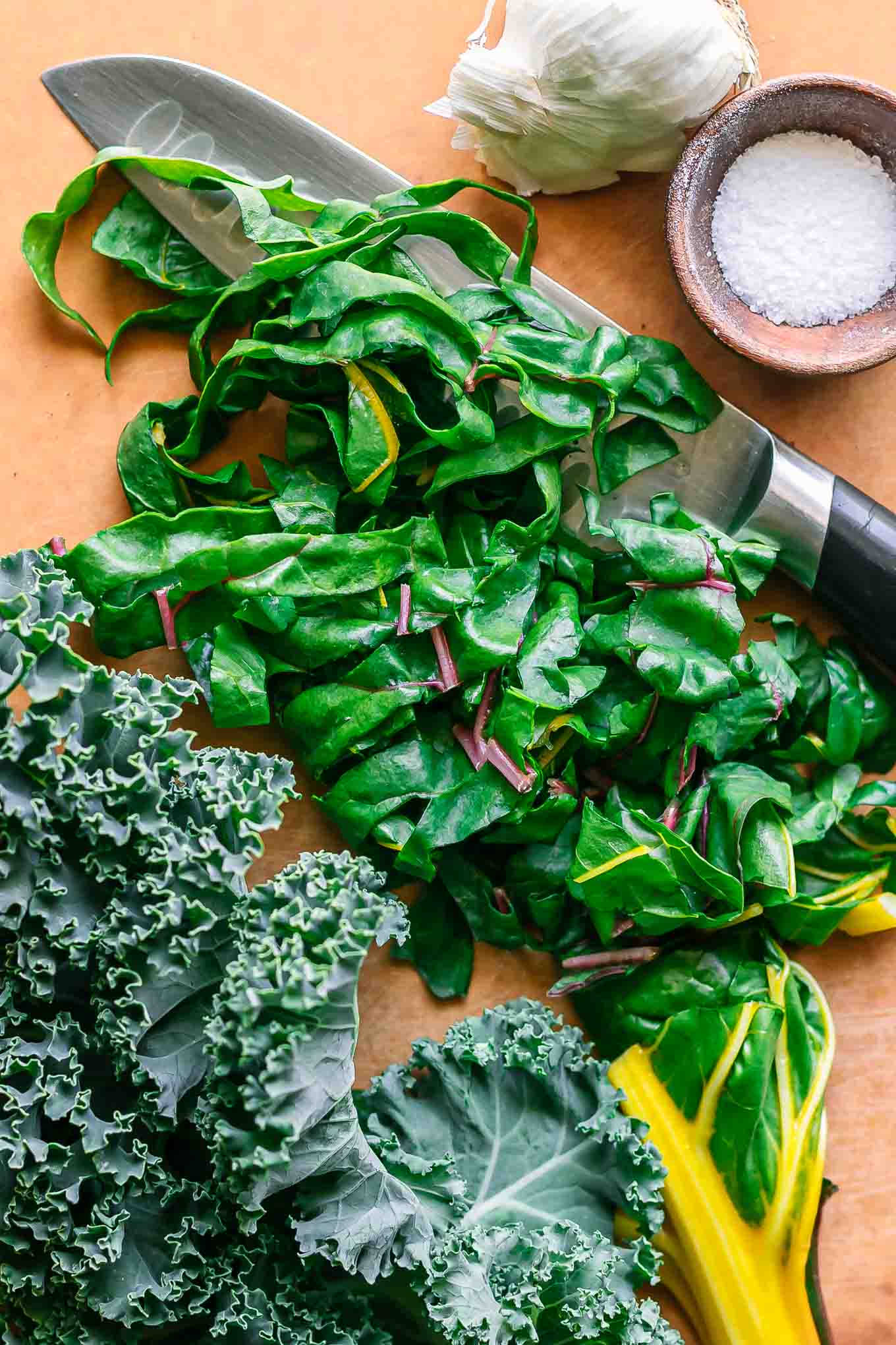 cut kale and chard on a wood cutting board