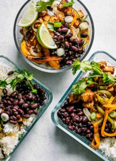 glass food storage bowls with tofu fajitas and rice on a white table for meal prep