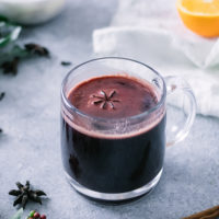 a hot mug of gluwhein on a christmas holiday table
