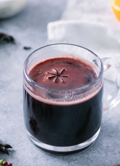 a hot mug of gluwhein on a christmas holiday table