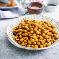 baked chickpeas in a bowl on a white table