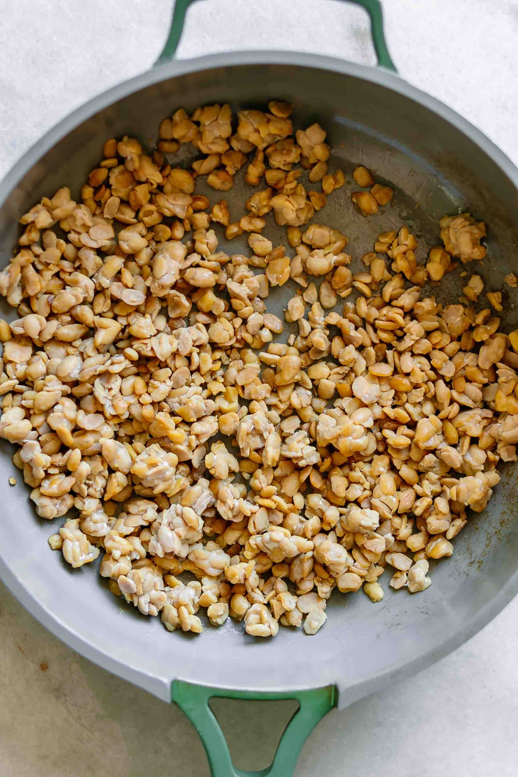 crumbled tempeh bacon in a pan before cooking