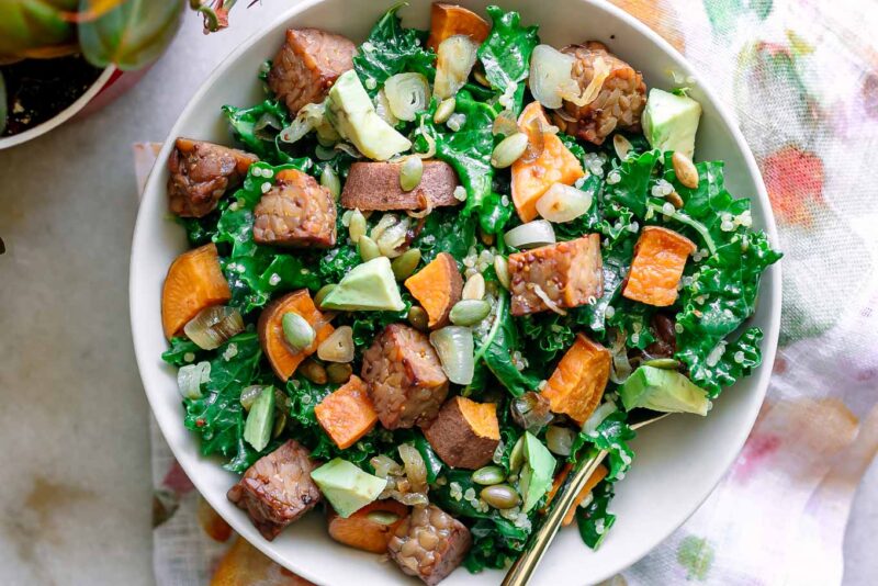 a kale and quinoa bowl with tempeh and sweet potatoes