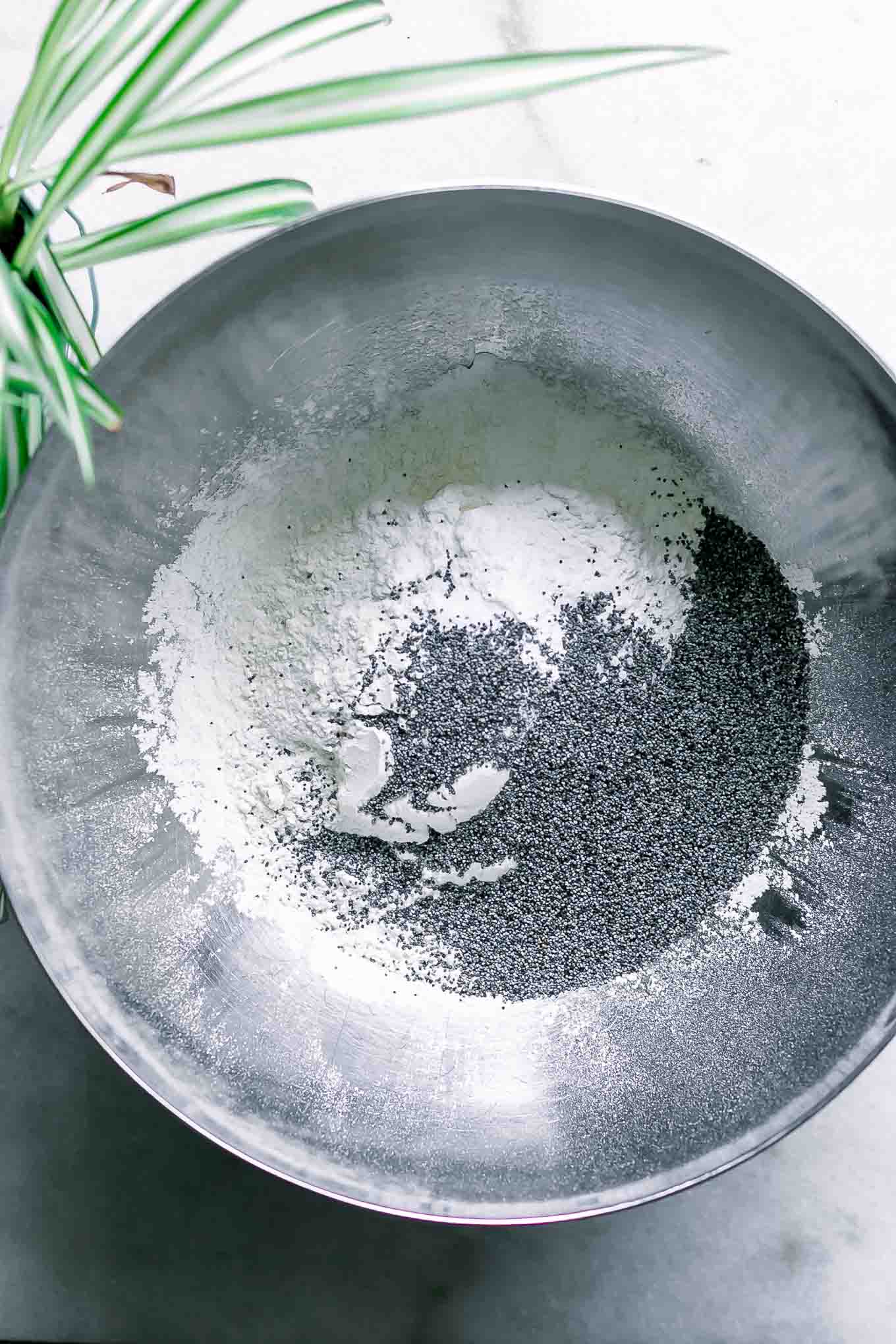 flour, baking soda, baking powder, poppyseeds, and salt in a bowl for muffins