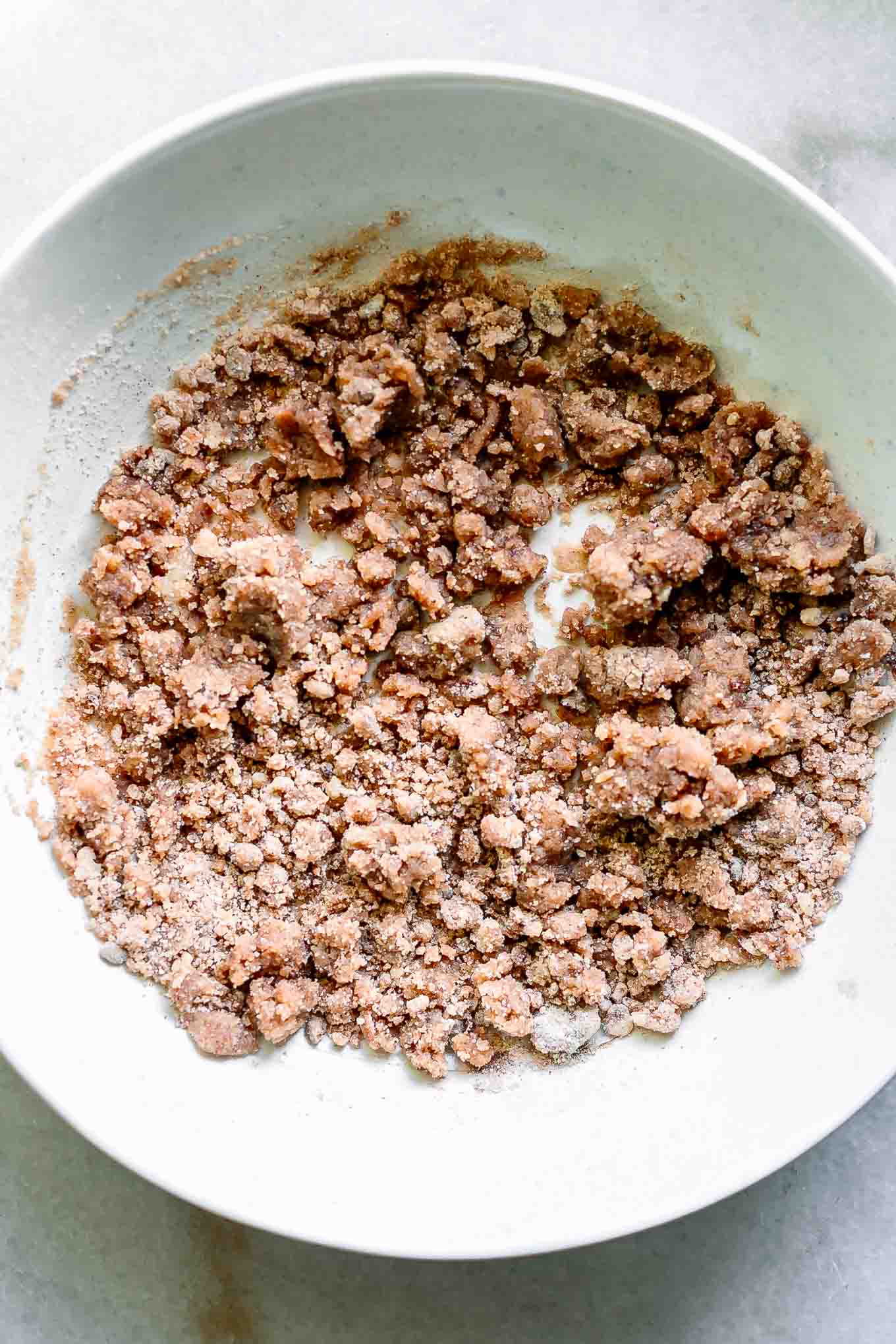 a bowl of muffin crumb topping on a white table