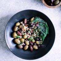 A mixture of green and kalamata olives with capers and herbs.